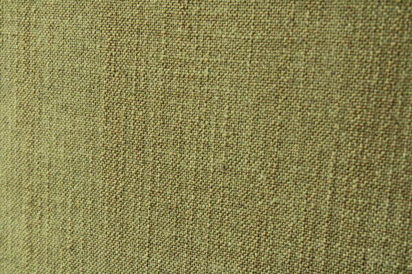 Detail van het groene Elegance gordijn, toont de natuurlijke textuur en de zachte, hoogwaardige afwerking.